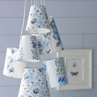 blue wall with hanging blue floral lampshades