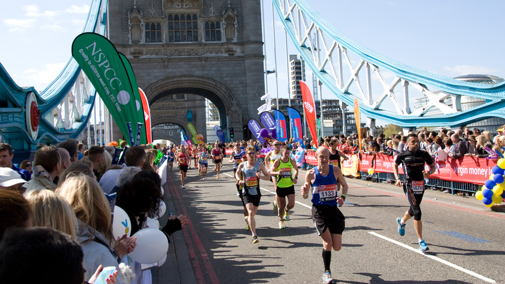London Marathon runners cross Tower Bridge