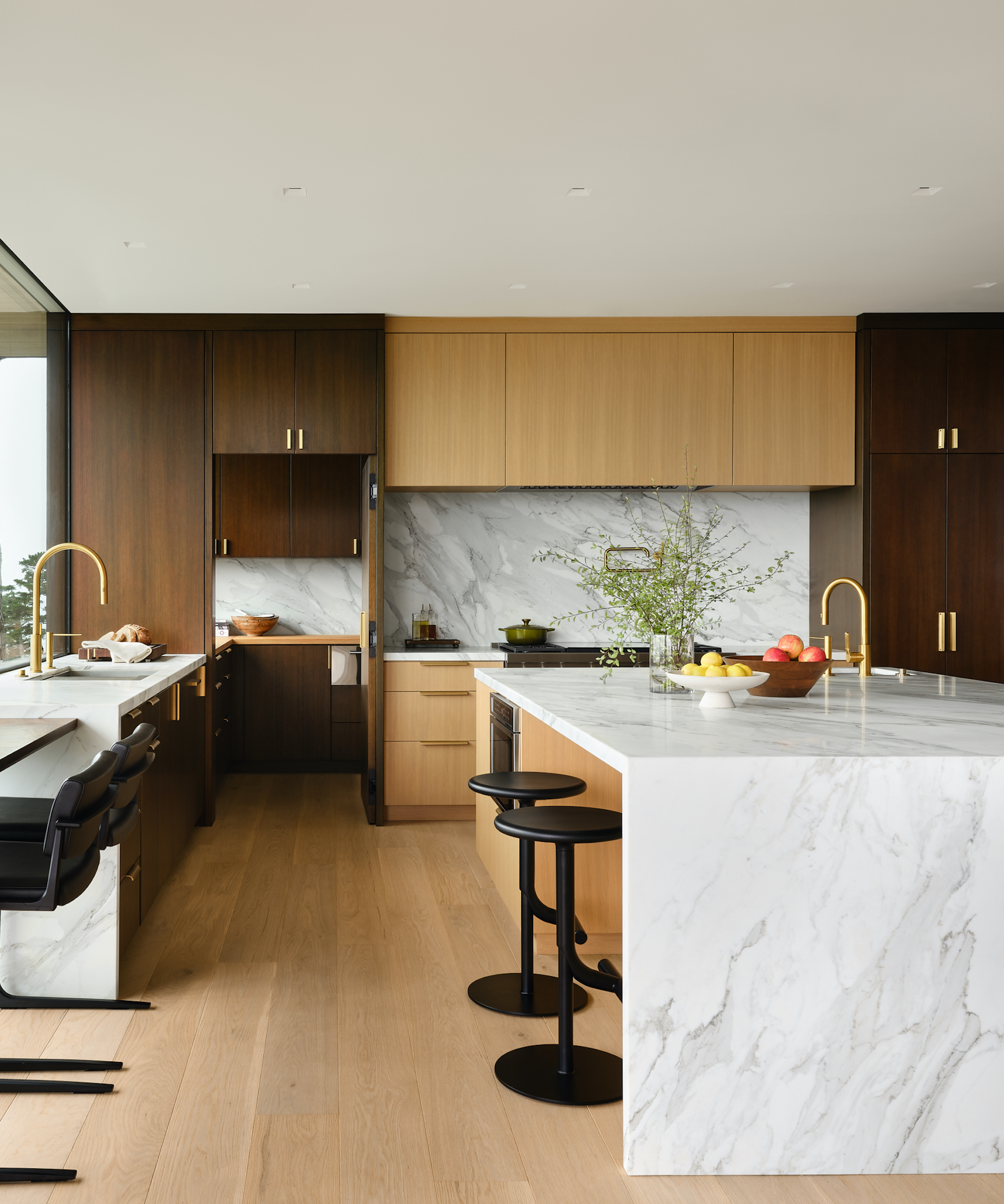 wood and marble kitchen with black and brass accents