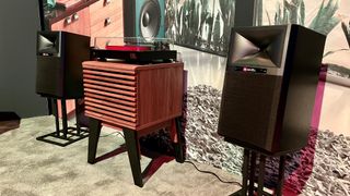 JBL 4329B speakers in room with Bluetooth turntable on stand 
