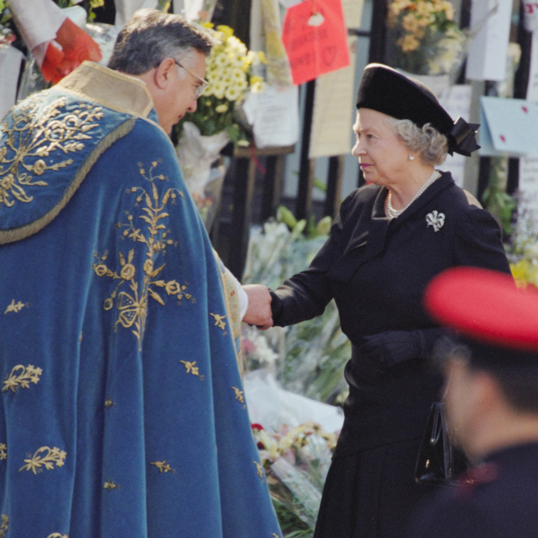 Queen Elizabeth shaking hands with a clergyman at Princess Diana's funeral