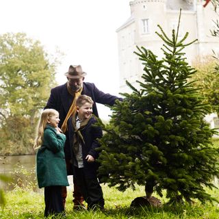 Dick, daughter Dorothy and son Arthur from Escape to The Chateau standing by a real Christmas tree in the grounds of their Chateau