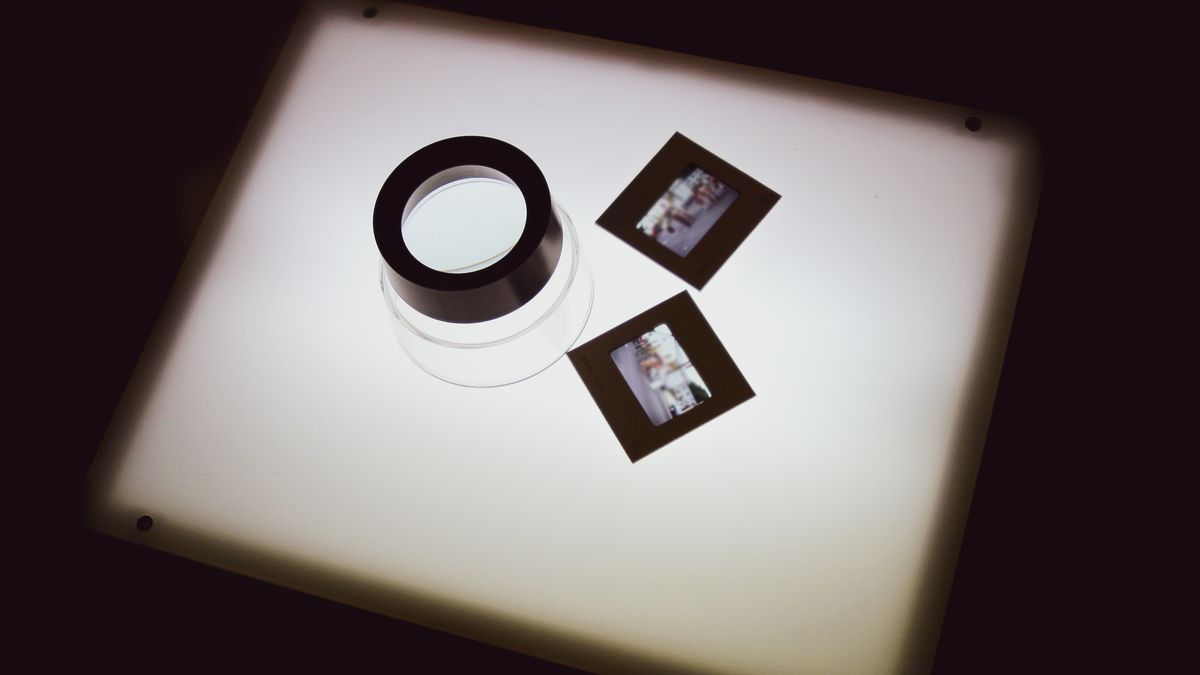 A pair of 35mm mounted slides and loupe on a lightbox