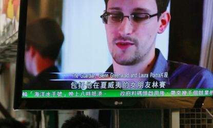 A TV screen in a Hong Kong restaurant shows a news report on Edward Snowden on June 12.