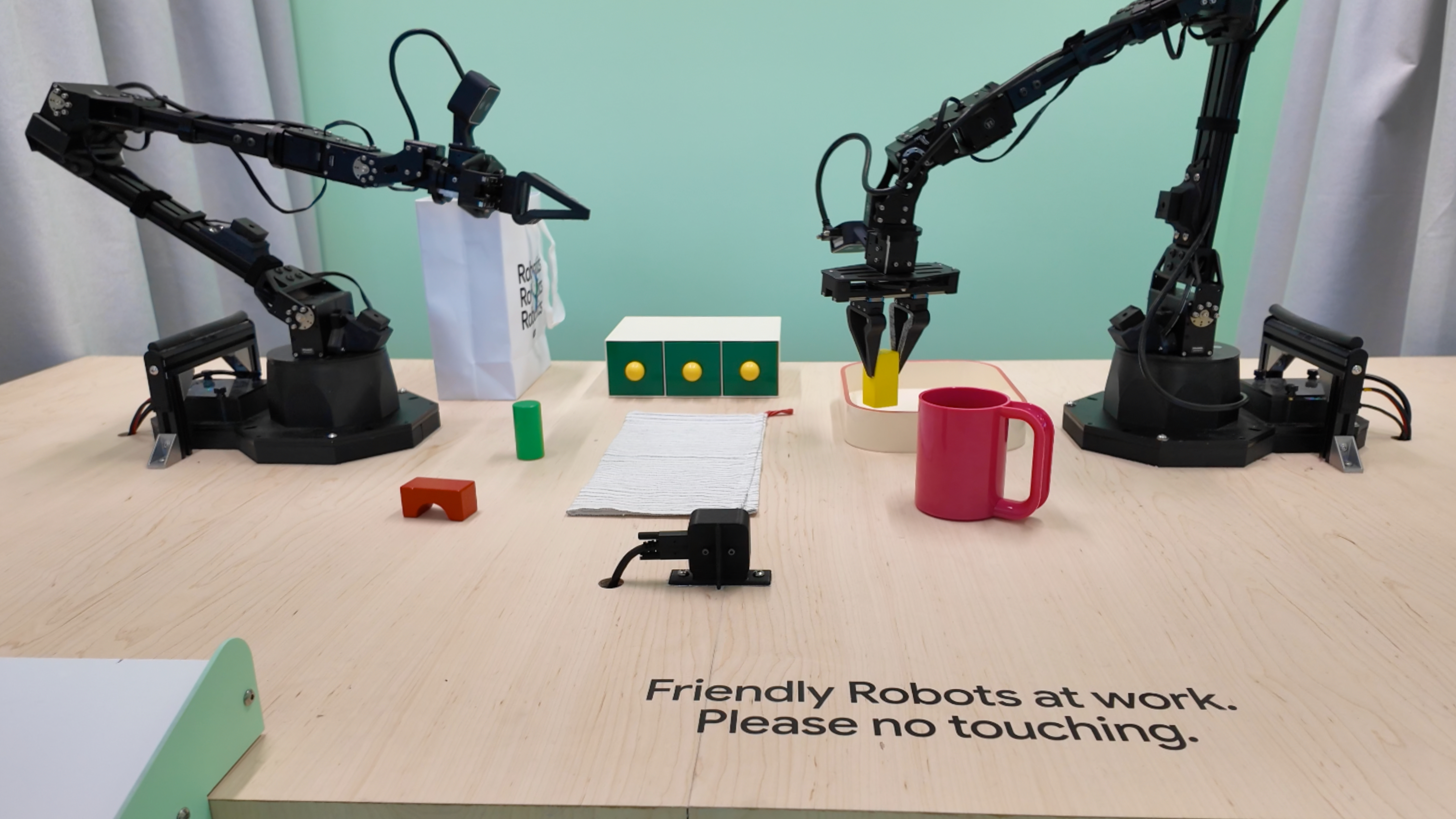 Robot arms picking up objects with Gemini.