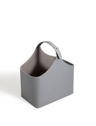A grey bucket style magazine rack