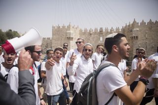 Israeli Jewish men walk by Damascus Gate during Jerusalem Day celebrations