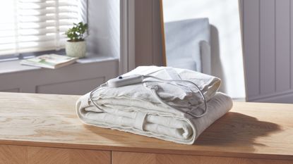 Aldi electric blanket folded on wooden table