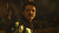 Pedro Pascal as Mandalorian looking to his side unmasked in The Mandalorian And Grogu
