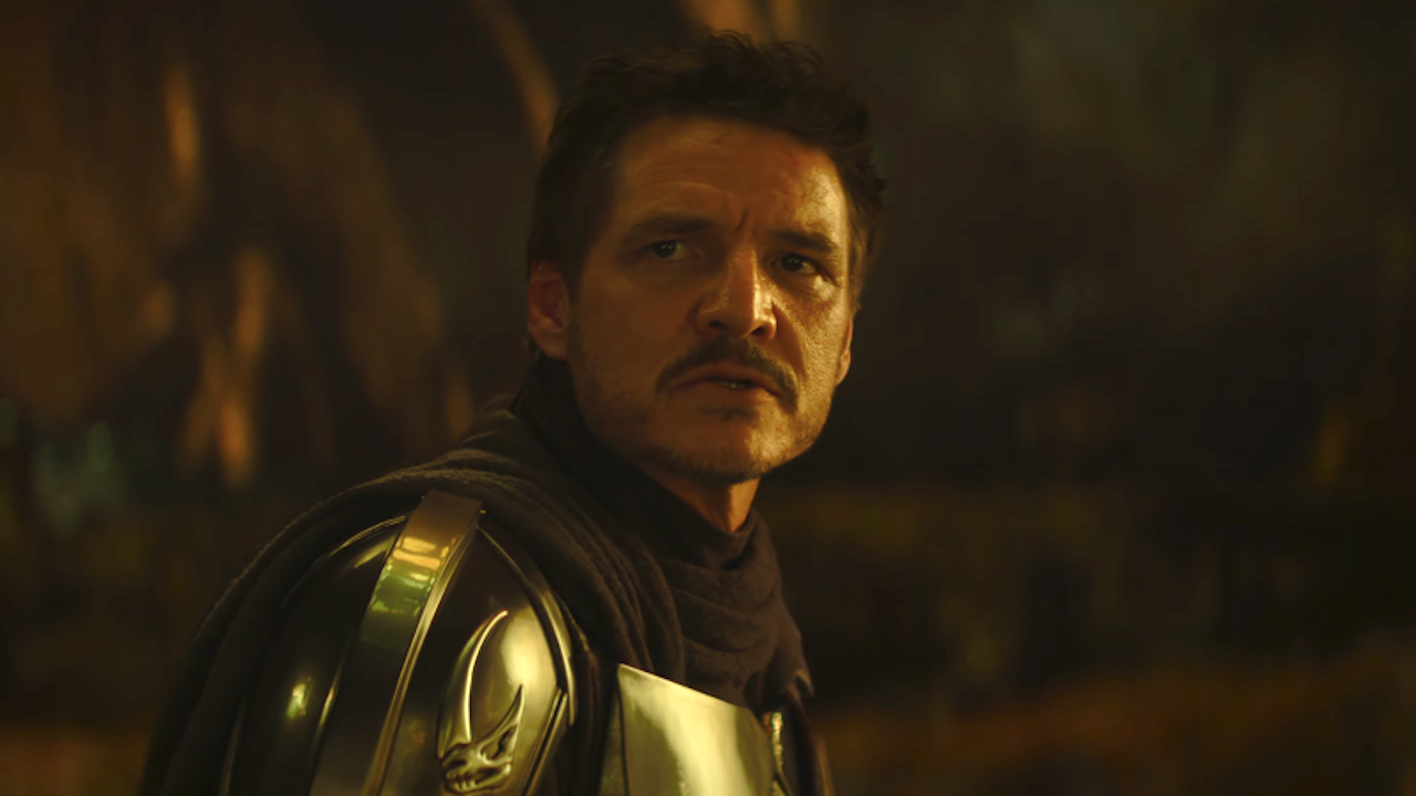 Pedro Pascal as Mandalorian looking to his side unmasked in The Mandalorian And Grogu