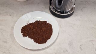 A plate of espresso grounds with some clumps