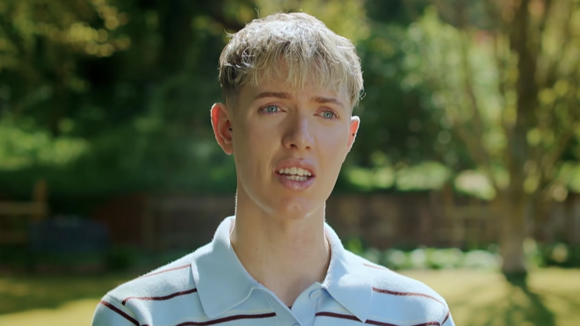 Tom in a blue polo talking about representing Northerners in the trailer for Bake Off.