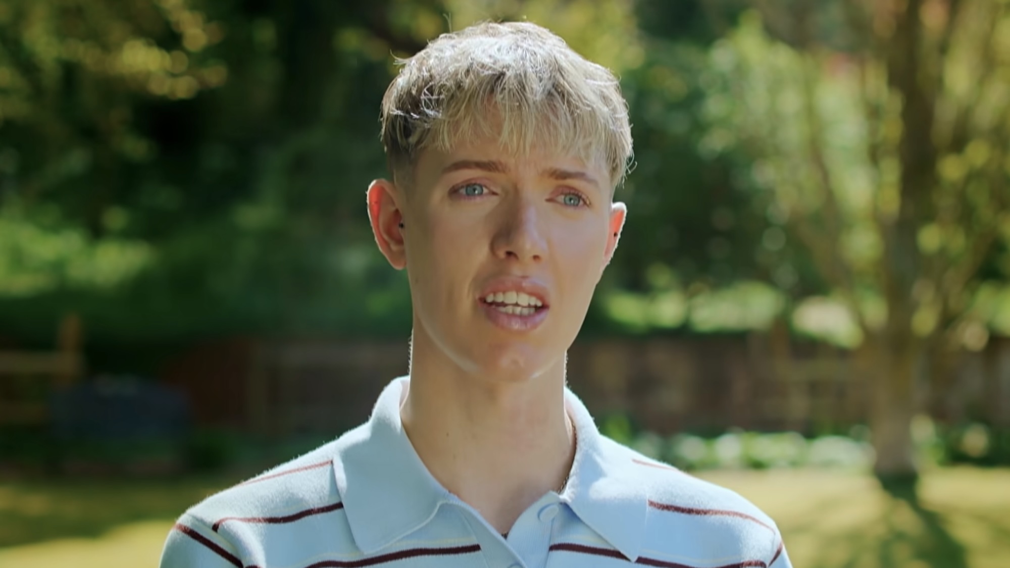 Tom in a blue polo talking about representing Northerners in the trailer for Bake Off.