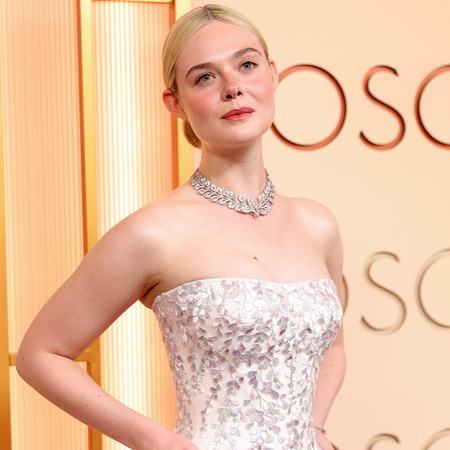 Elle Fanning wearing a white gown at on the Oscars 2026 red carpet.