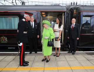 Queen Elizabeth II and Meghan, Duchess of Sussex arrive by Royal Train at Runcorn Station to open the new Mersey Gateway Bridge on June 14, 2018