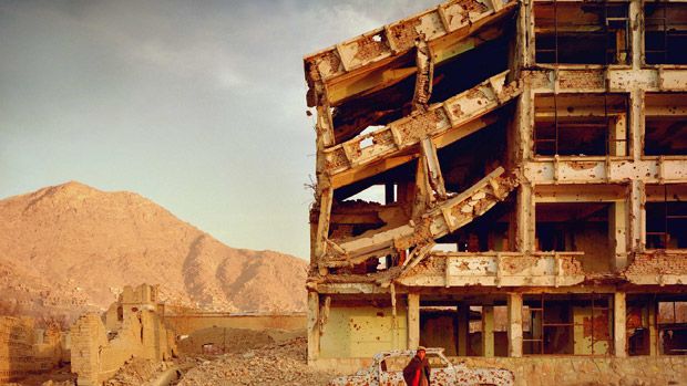 Bullet-scarred apartment building and shops in the Karte Char district of Kabul.