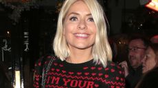 holly willoughby smiling in a christmas sweater