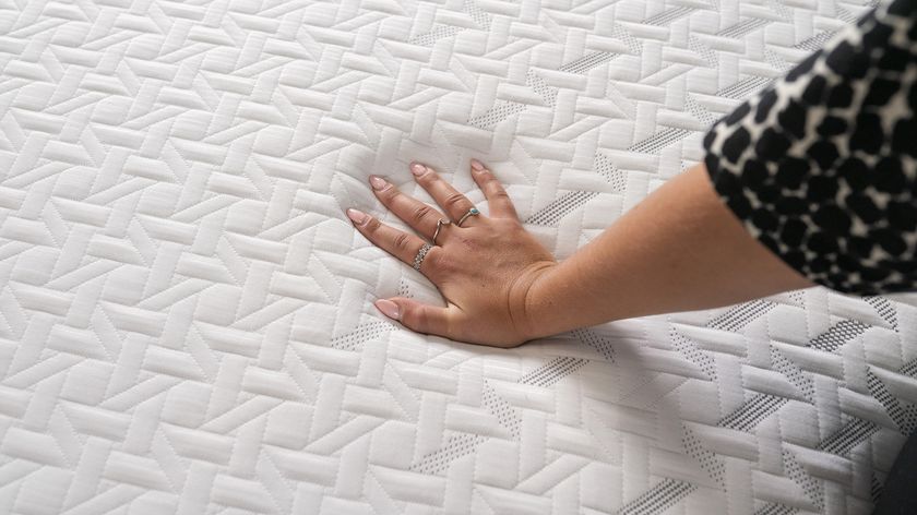 A hand presses into the Nectar Classic Memory Foam Mattress to test the temperature regulation and pressure relief