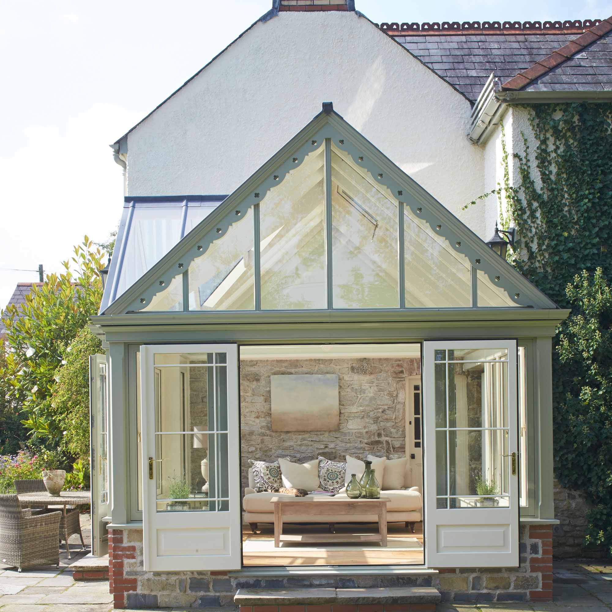 traditional sage green conservatory with French doors