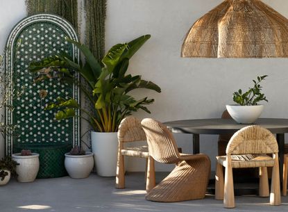 A backyard decorated with boho style outdoor furniture