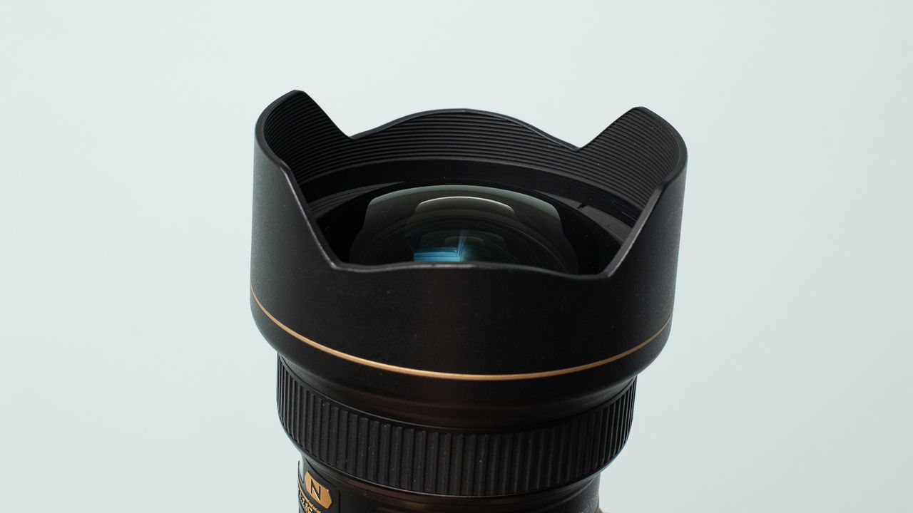 Image shows the front element and fitted hood on the Nikon AF-S 14/24mm f/2.8 ED lens.