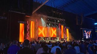 The stage lit up in orange at UNITE San Antonio with sounds brought to life by JBL Professional.