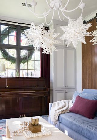 Paper stars on light pendant, Christmas decorations in living room by Marie Flanigan