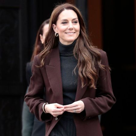 Kate Middleton wears pinstripe trousers.