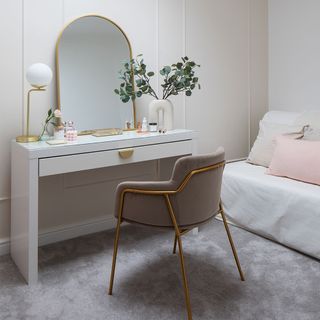 spare bedroom with dressing table chair and mirror