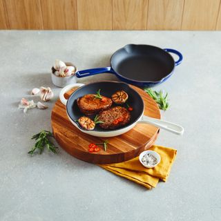 Cast iron cookware on chopping board