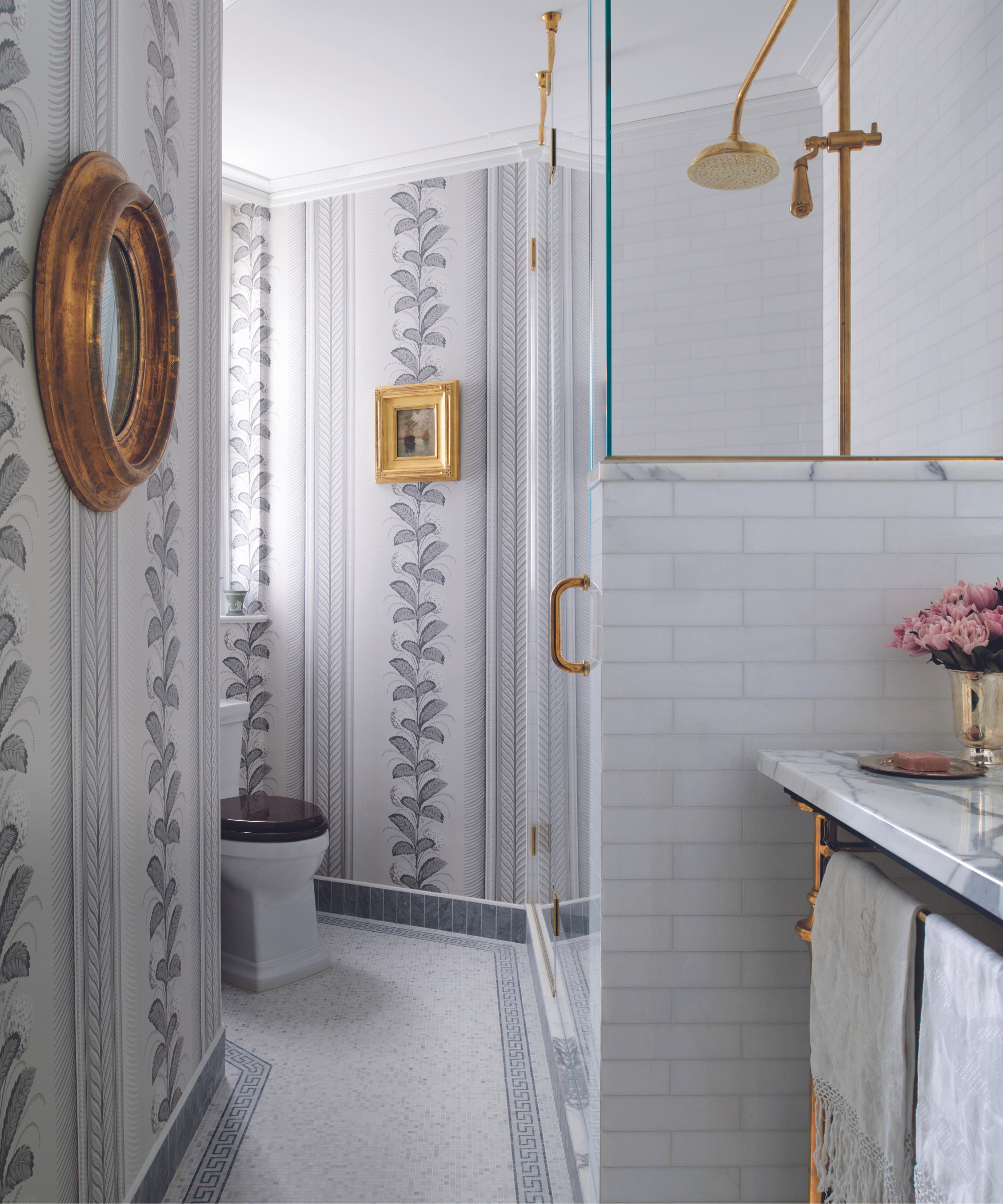 bathroom with wallpaper and gold fittings