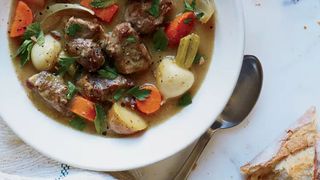 bowl of irish lamb stew with turnips in a white bowl