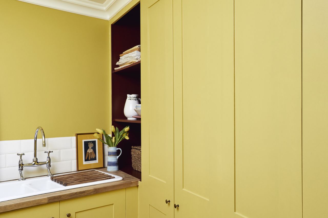 Yellow shaker style utility room with wooden worktop