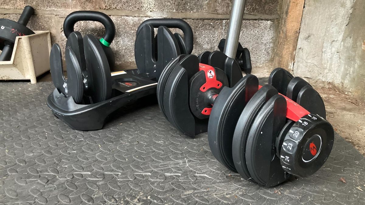 Bowflex 552i selectorized dumbbell next to docking station