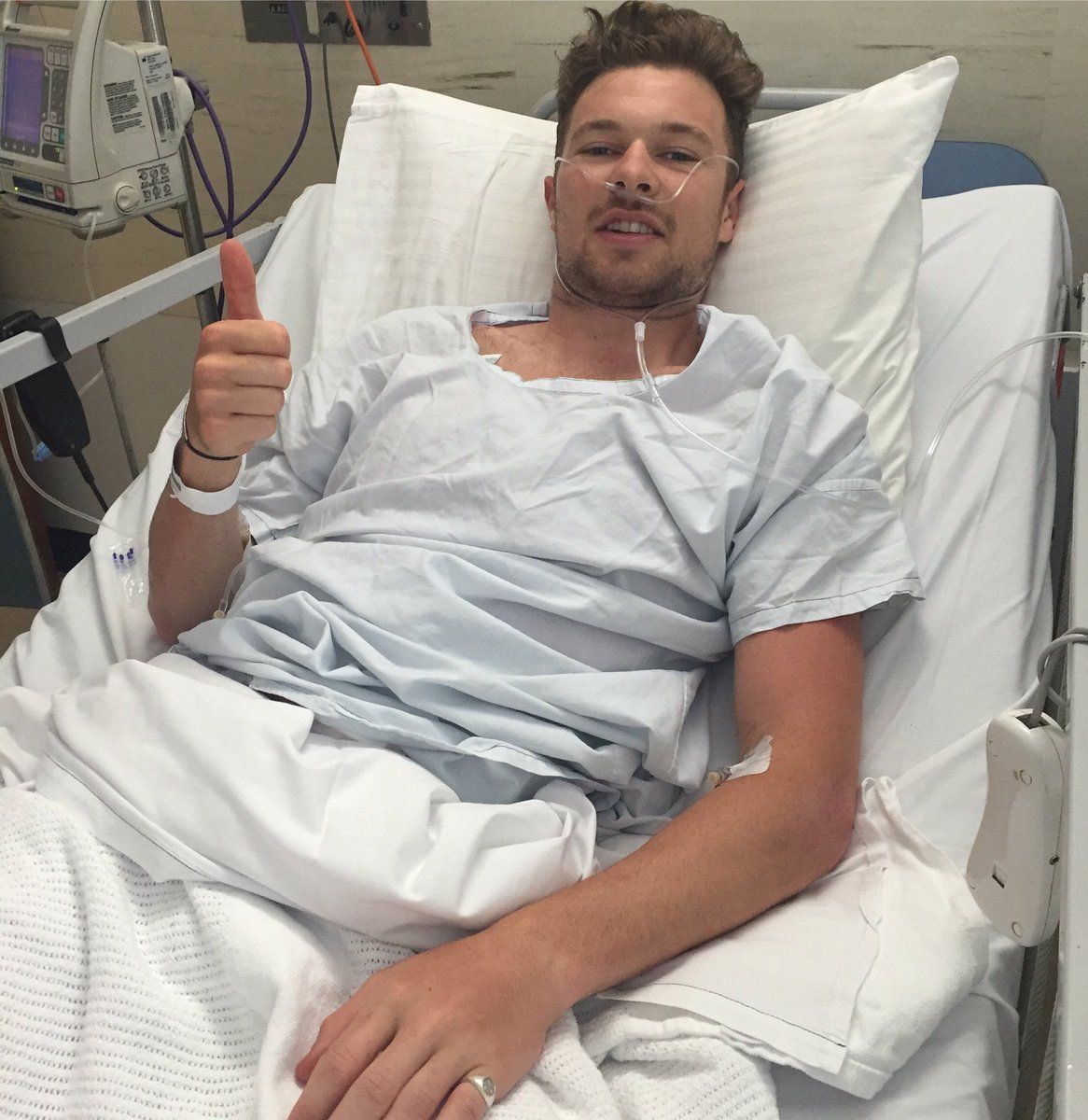 Owain Doull gives the thumbs up from his hospital bed
