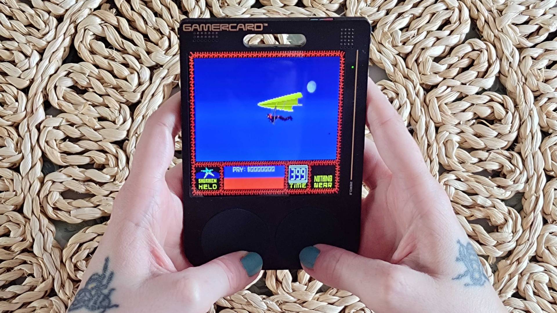 Hands using Gamercard to play Saboteur 2.