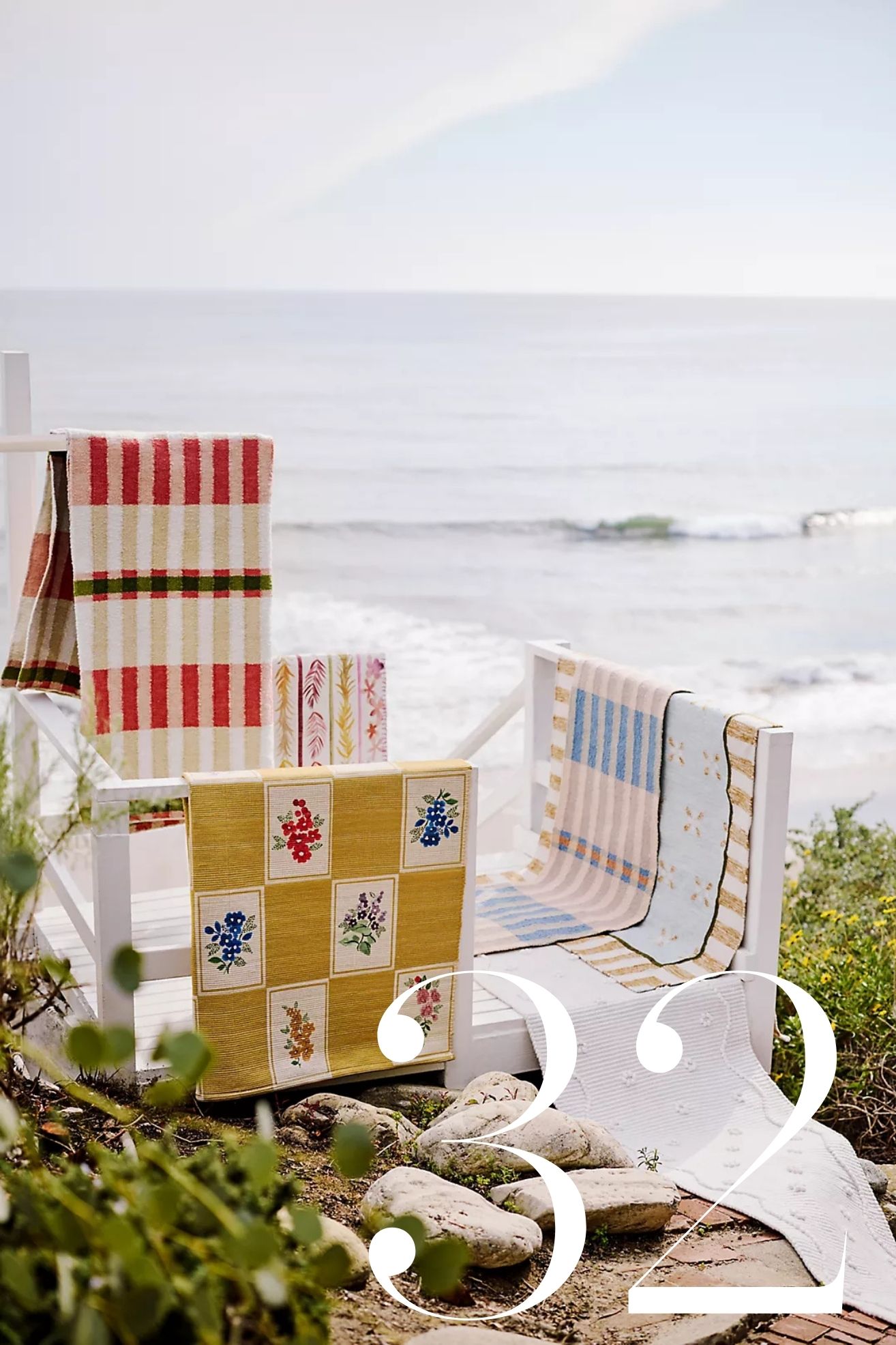 outdoor rugs draped over staircase leading down to a beach
