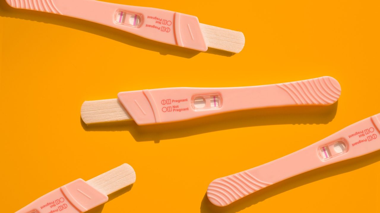 Pregnancy test against an orange background