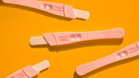 Pregnancy test against an orange background