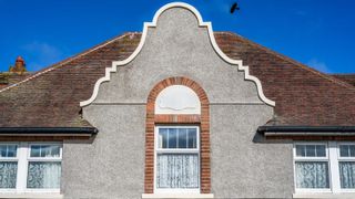 period property with ornately shaped gable end and pebbledash exterior