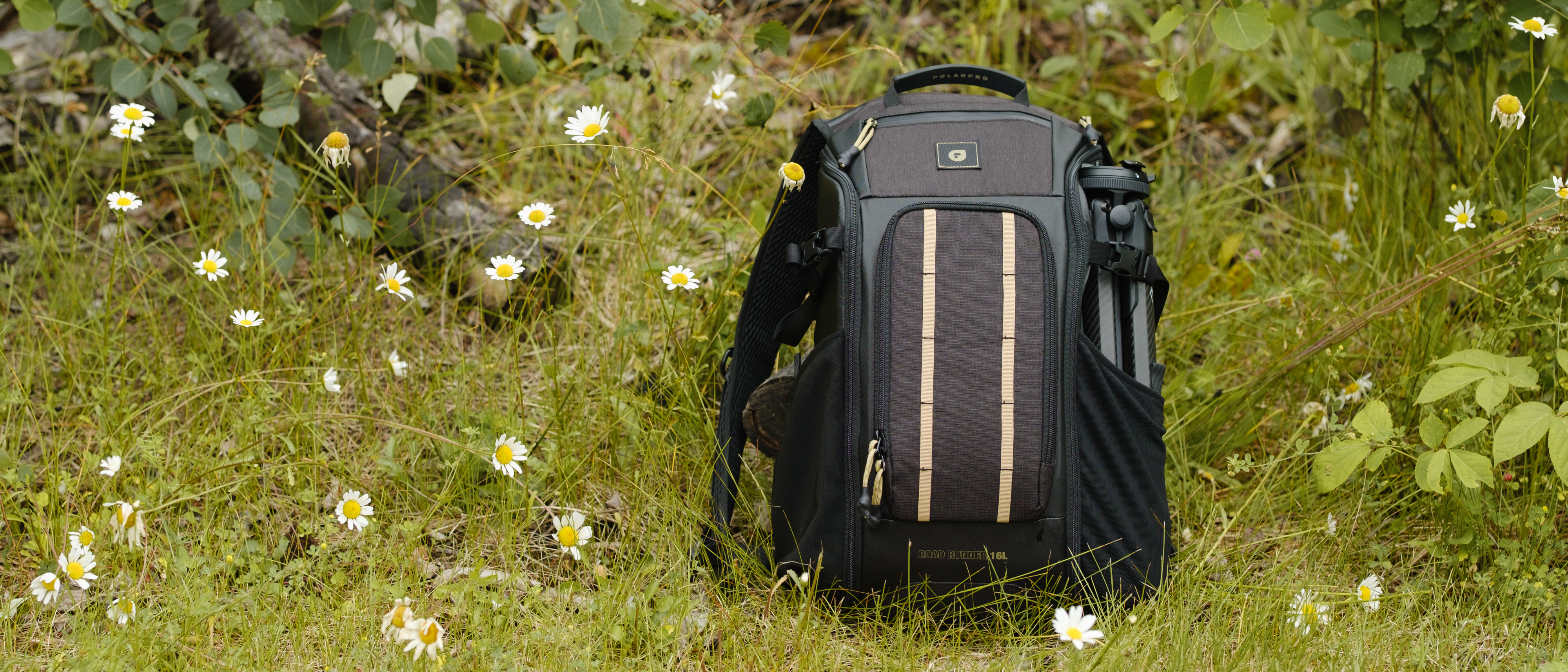 The PolarPro RoadRunner 16L backpack sitting in wildflowers