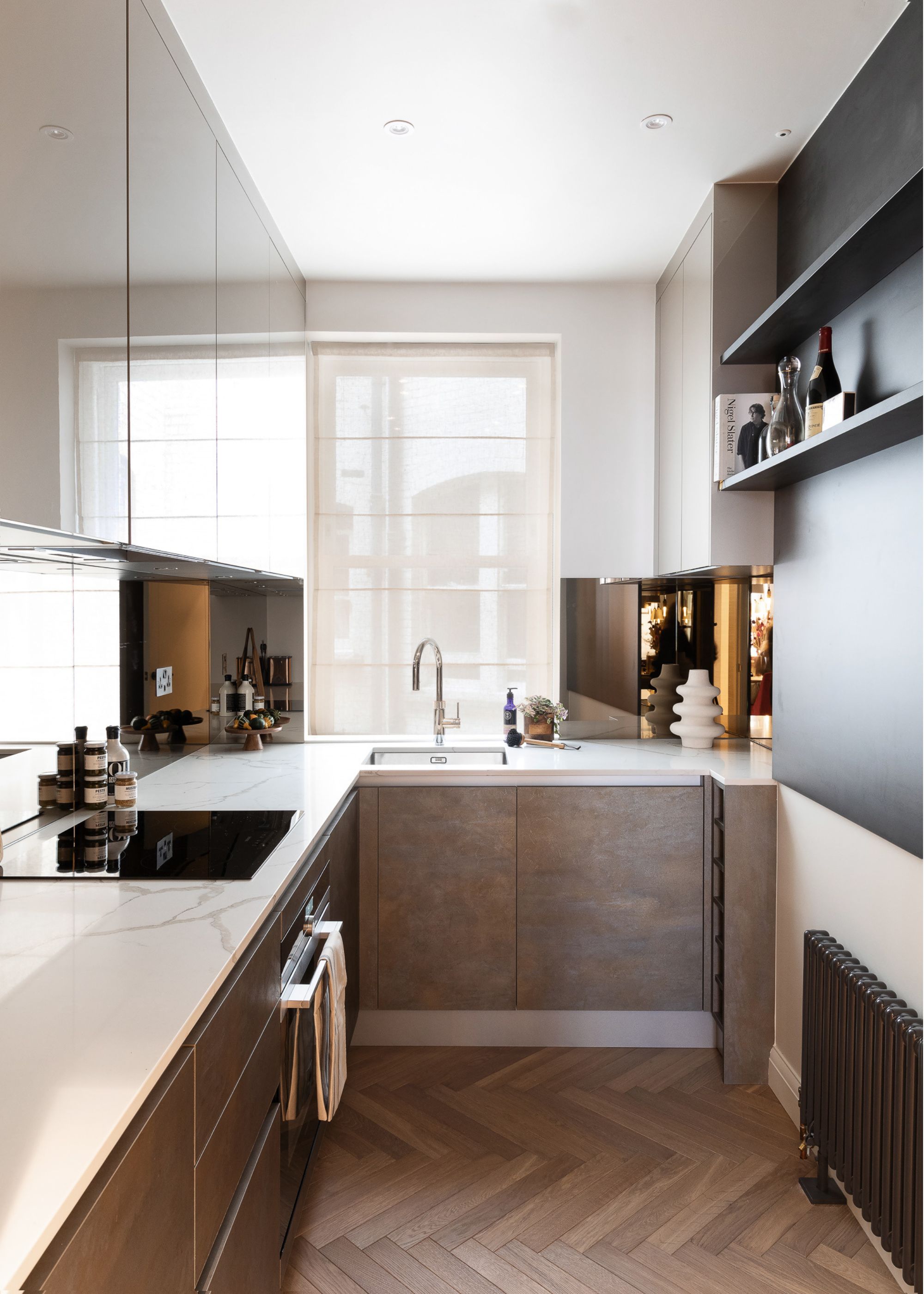 modern kitchen with white walls, parquet flooring and window with voile roman blinds