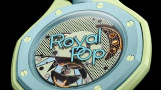 A close-up view of the back of a light green and blue octagonal watch shows its exposed mechanical movement through a transparent case back, with the stylized blue text "Royal Pop" printed in the center.