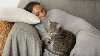 woman taking a nap with her cat