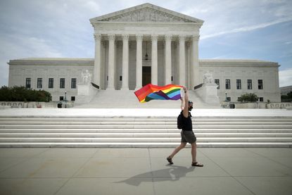 A rainbow flag in front of the Supreme Court