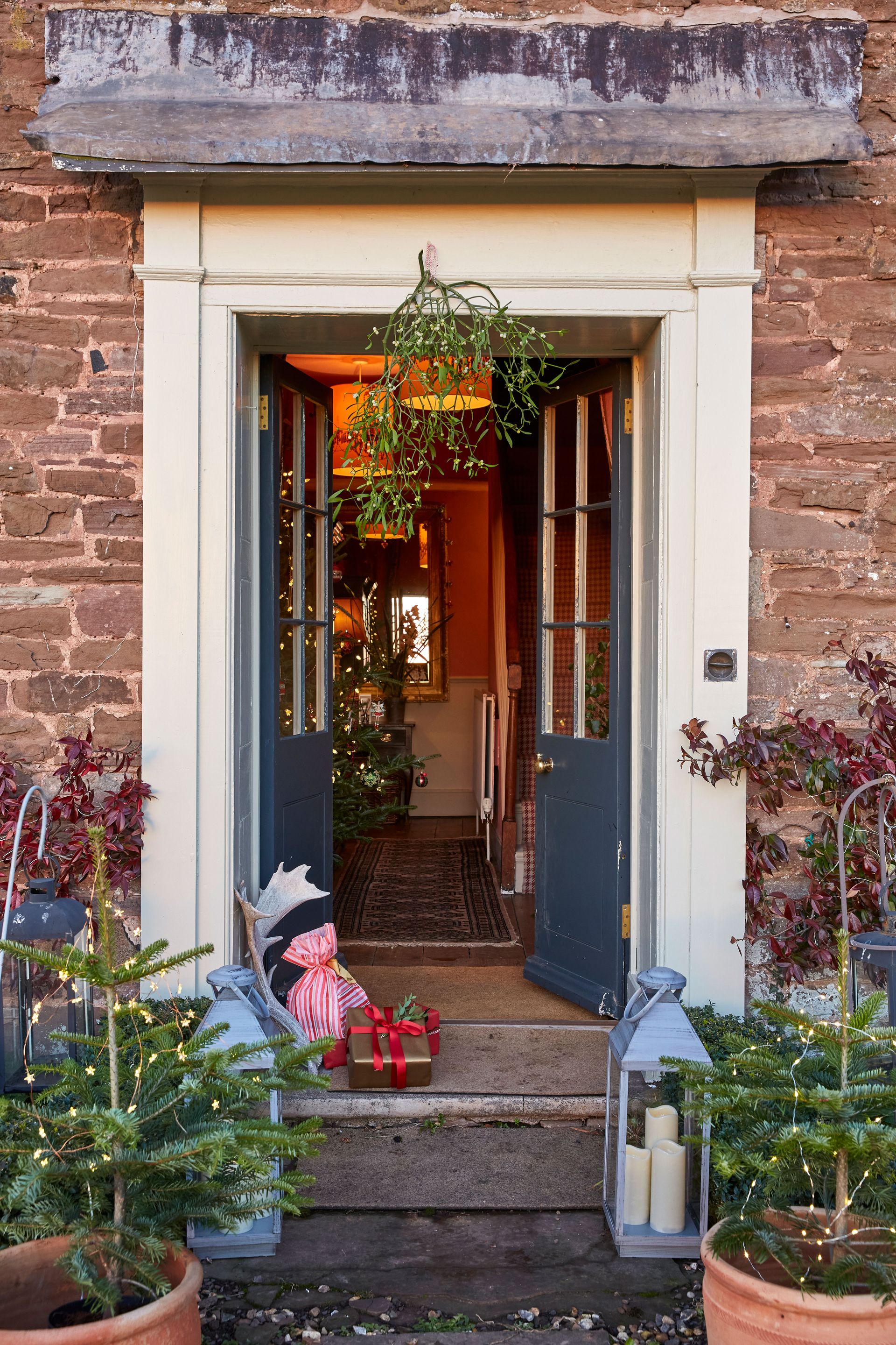 front door of country home decorated for Christmas