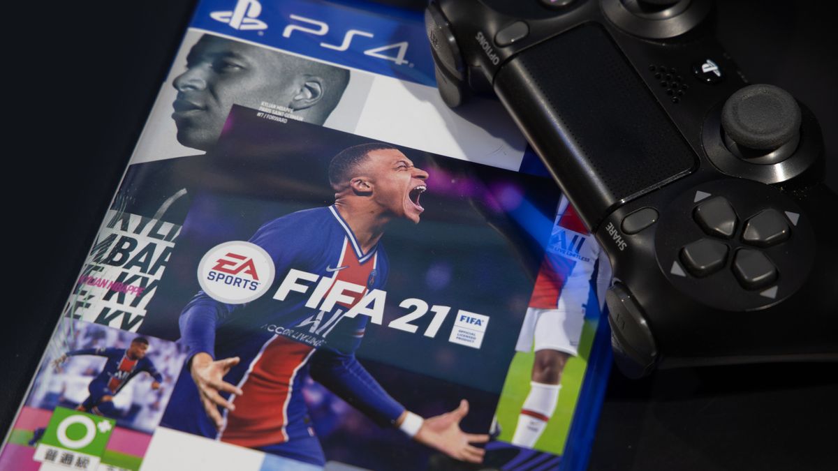 The box of the FIFA 21 title published by EA, with a PS4 controller