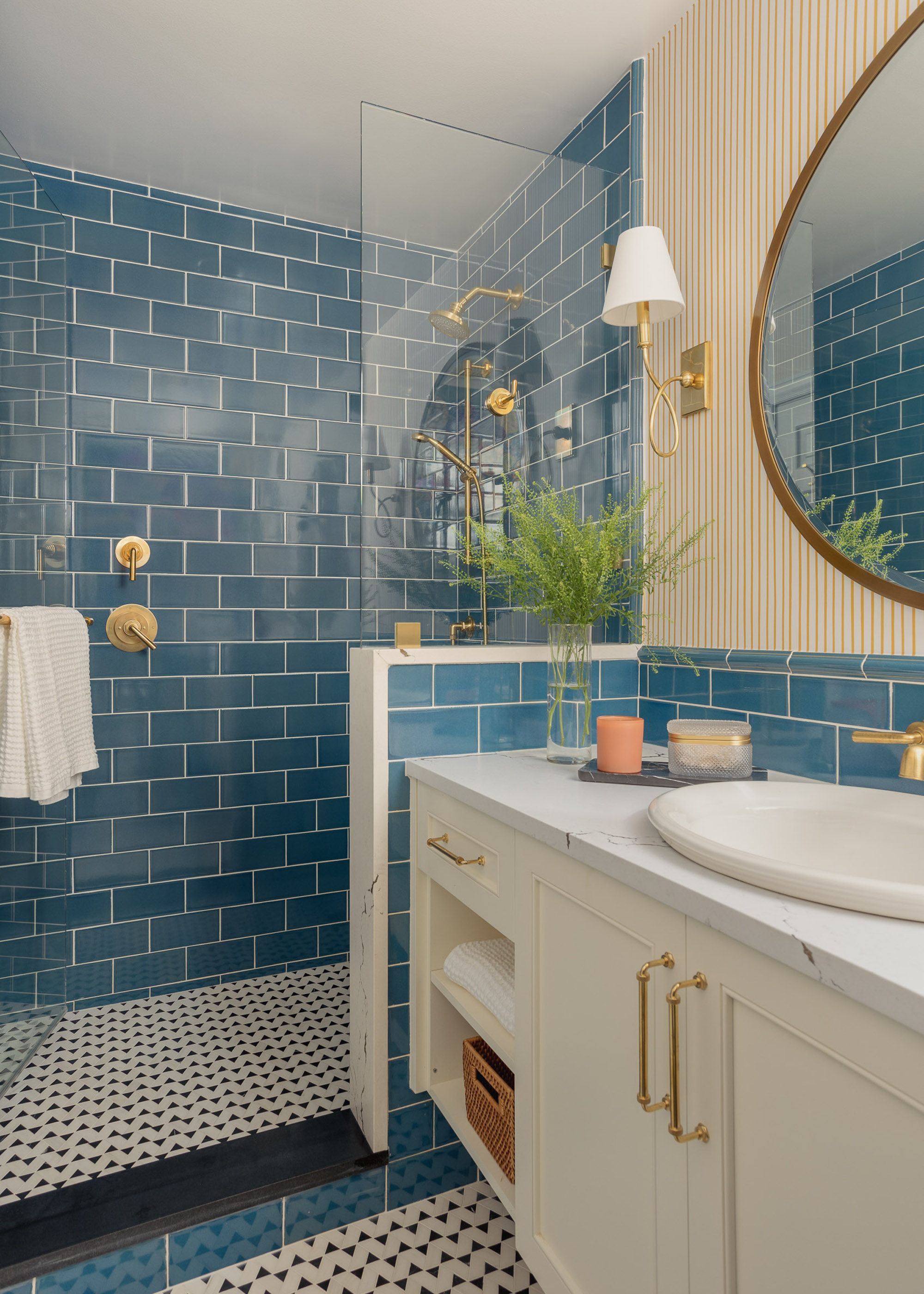 shower with blue subway tiles and white vanity