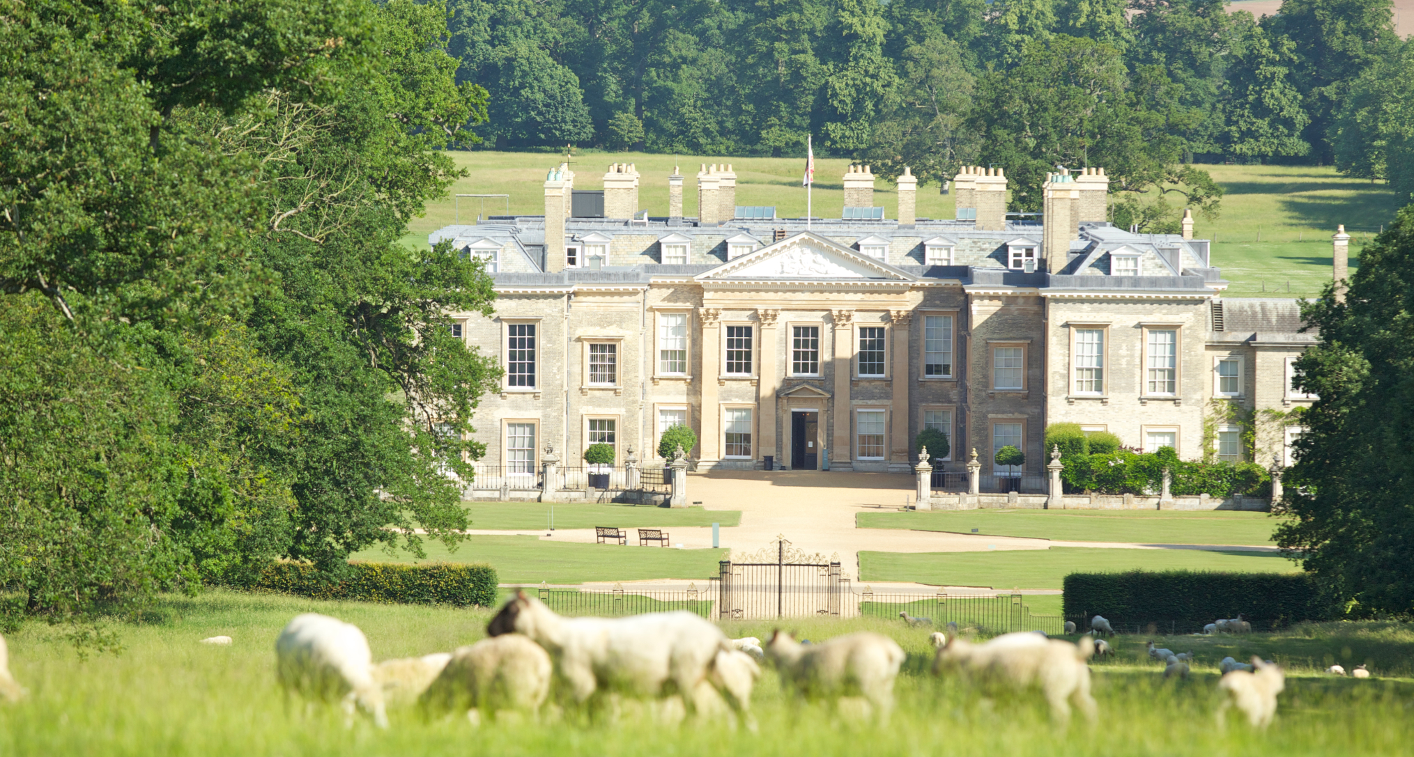 The exterior of Althorp House with sheep in the foreground