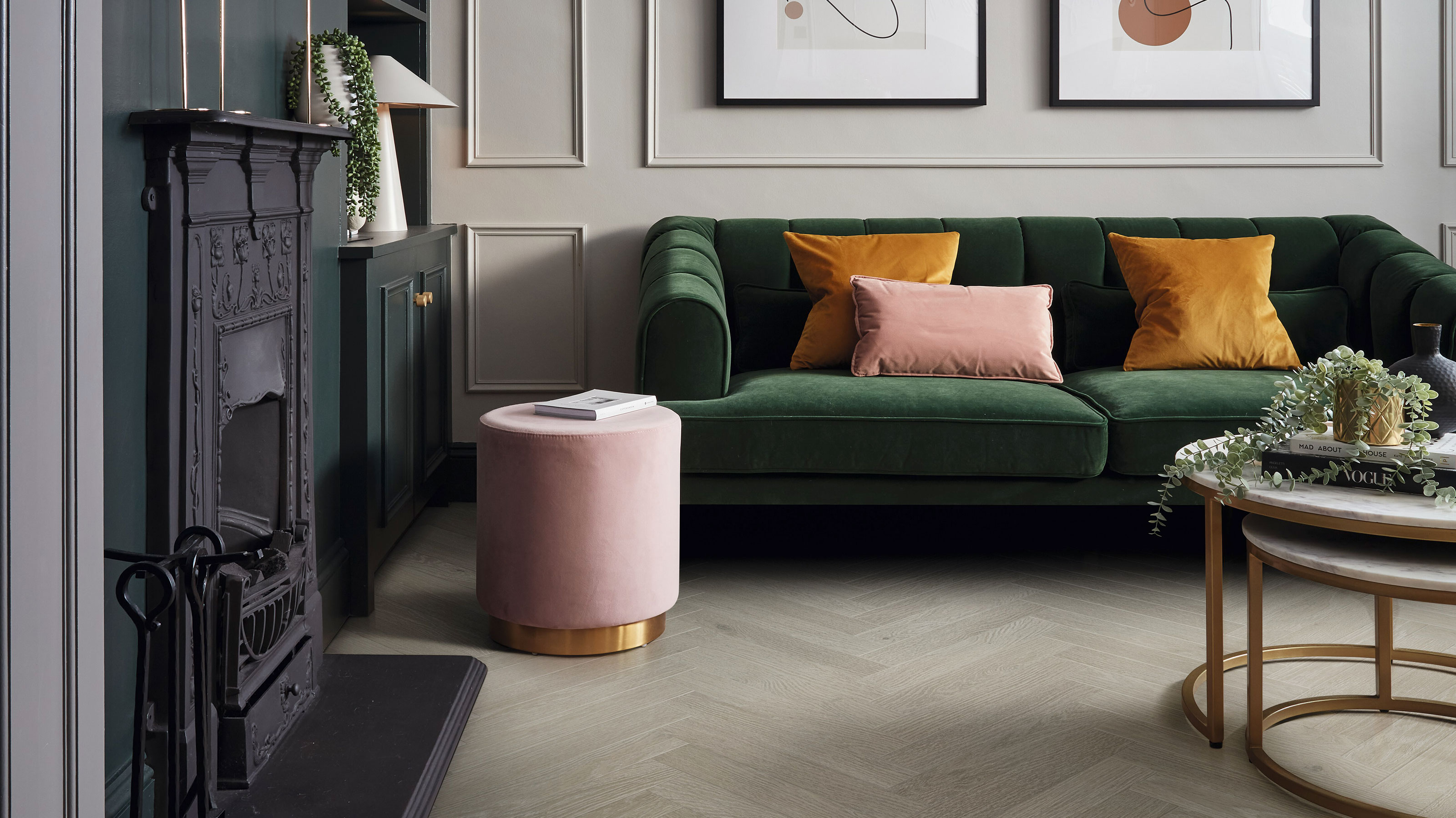 Living room with wood effect LVT floor in parquet pattern and a green velvet sofa